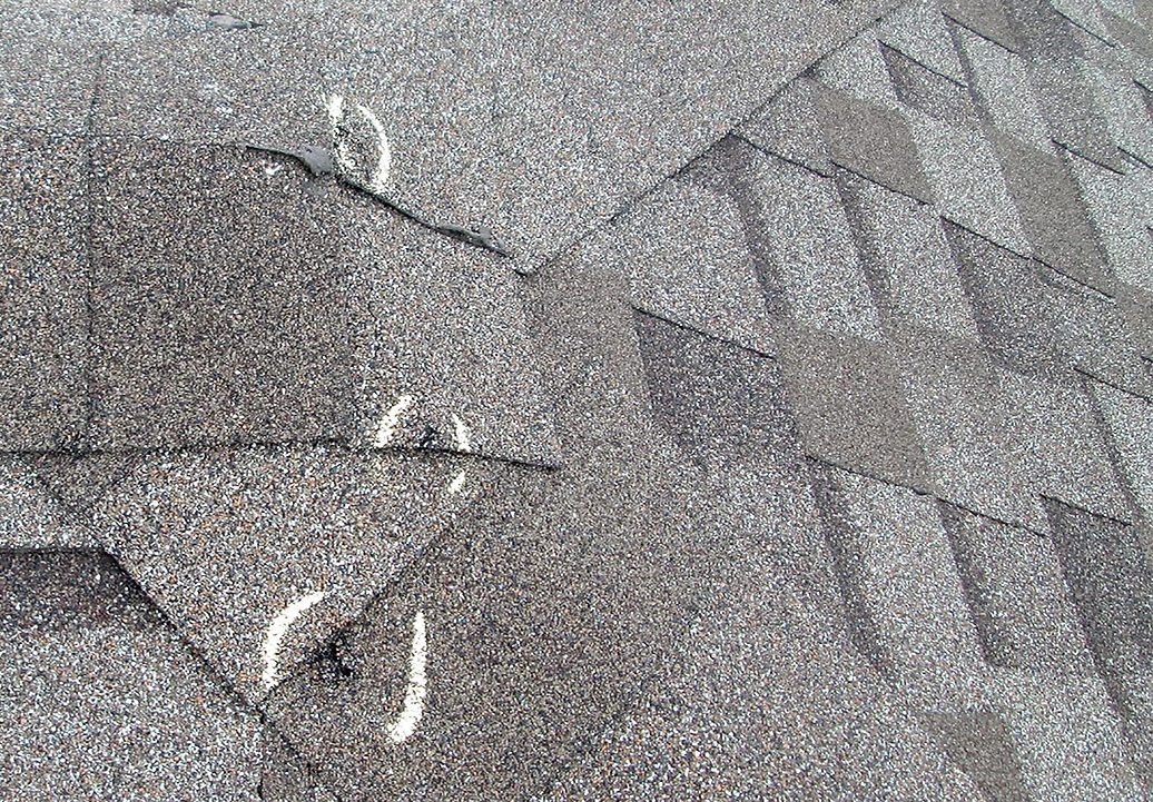 Midwest hail damage bruised asphalt shingles requiring full roof replacement