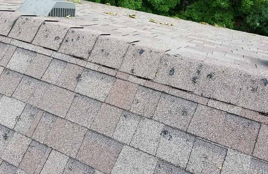 Ridge cap shingle damage from Midwest hail damage documented in an honest claim scope
