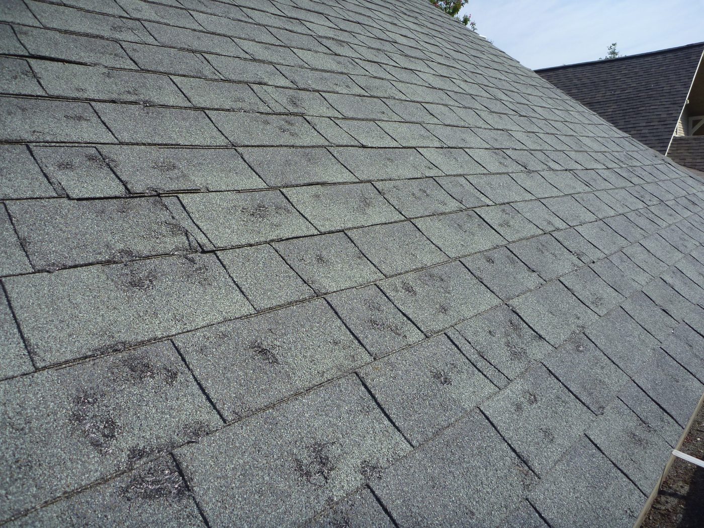 Midwest hail damage roof inspection chalk marked slope - John Beal Roofing crew documentation