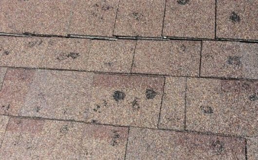 Midwest hail damage shingle wear versus hail - John Beal Roofing crew