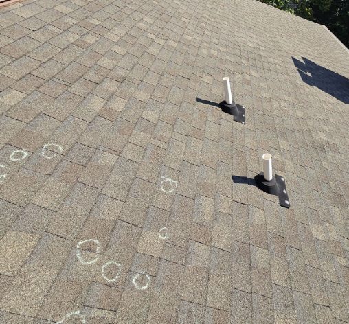 Midwest hail damage soft metal vent dents documented during roof inspection